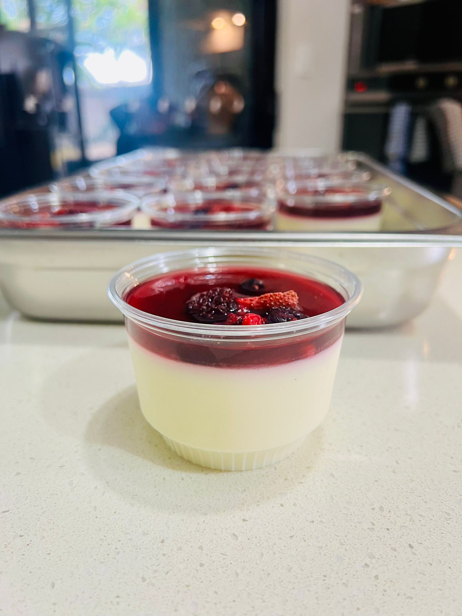 Vanilla panna cotta mini dessert cup with mixed berry jelly