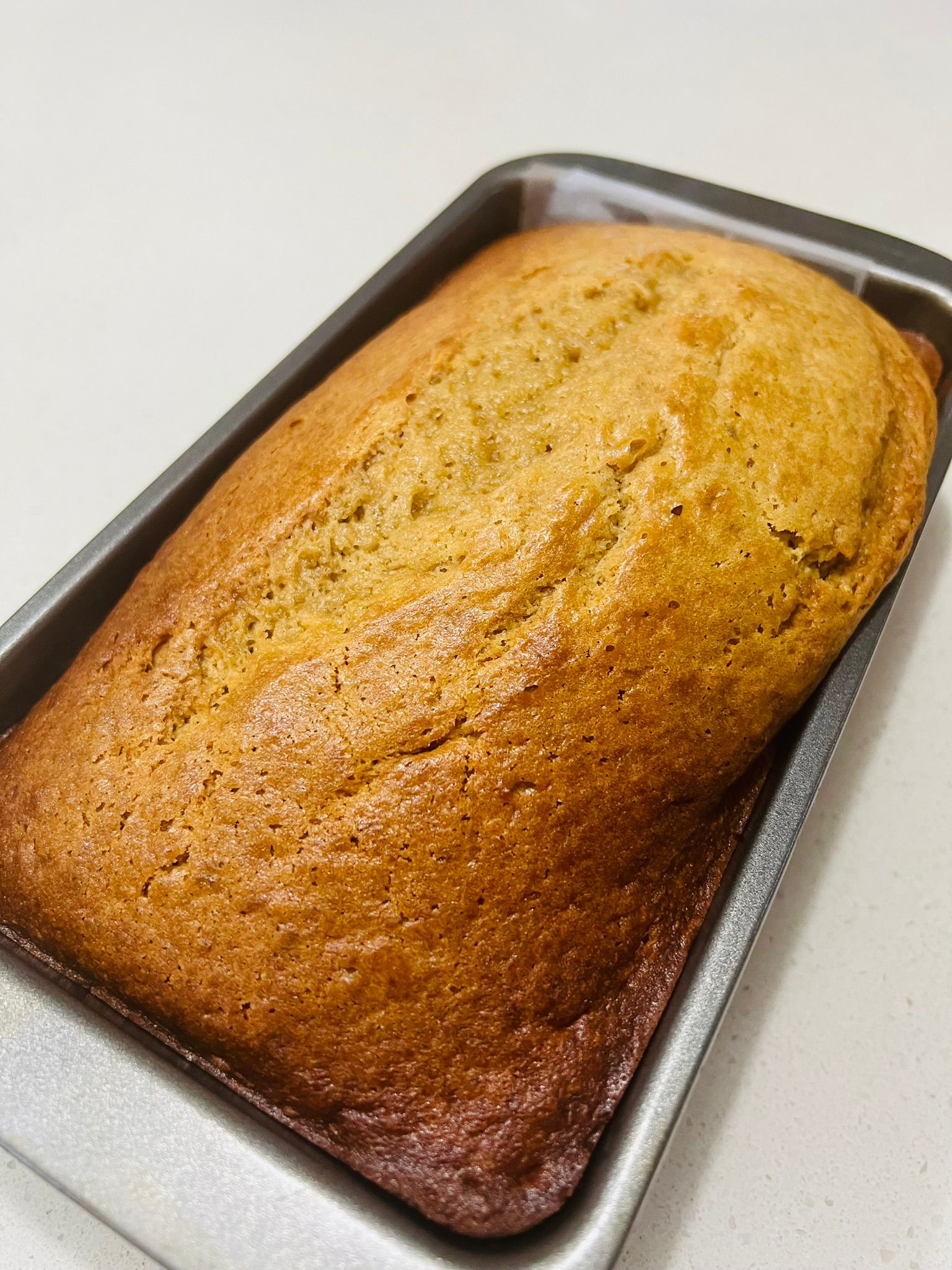 Original banana bread loaf — golden, freshly baked