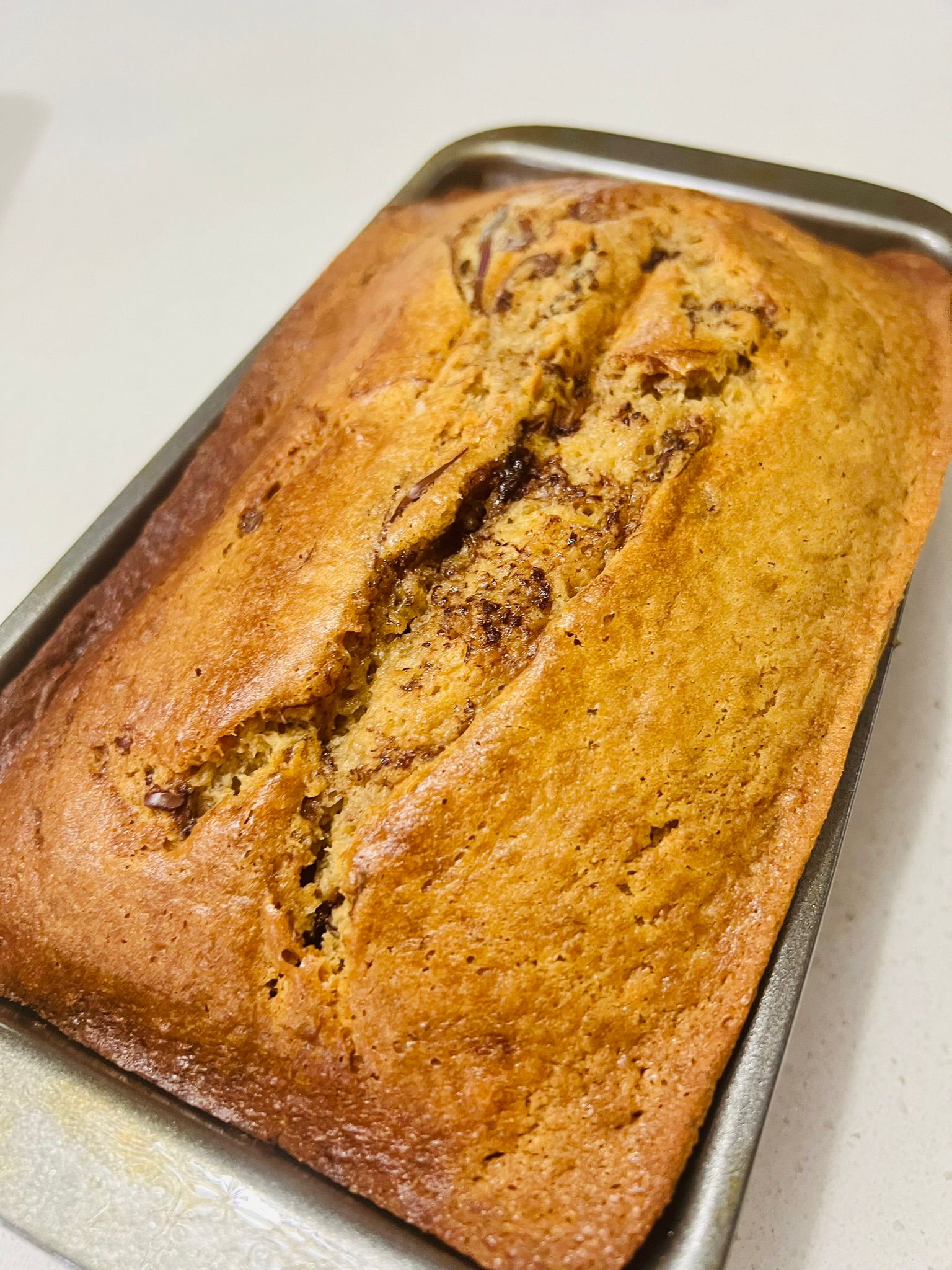 Nutella banana bread loaf — golden top with a Nutella swirl through the centre