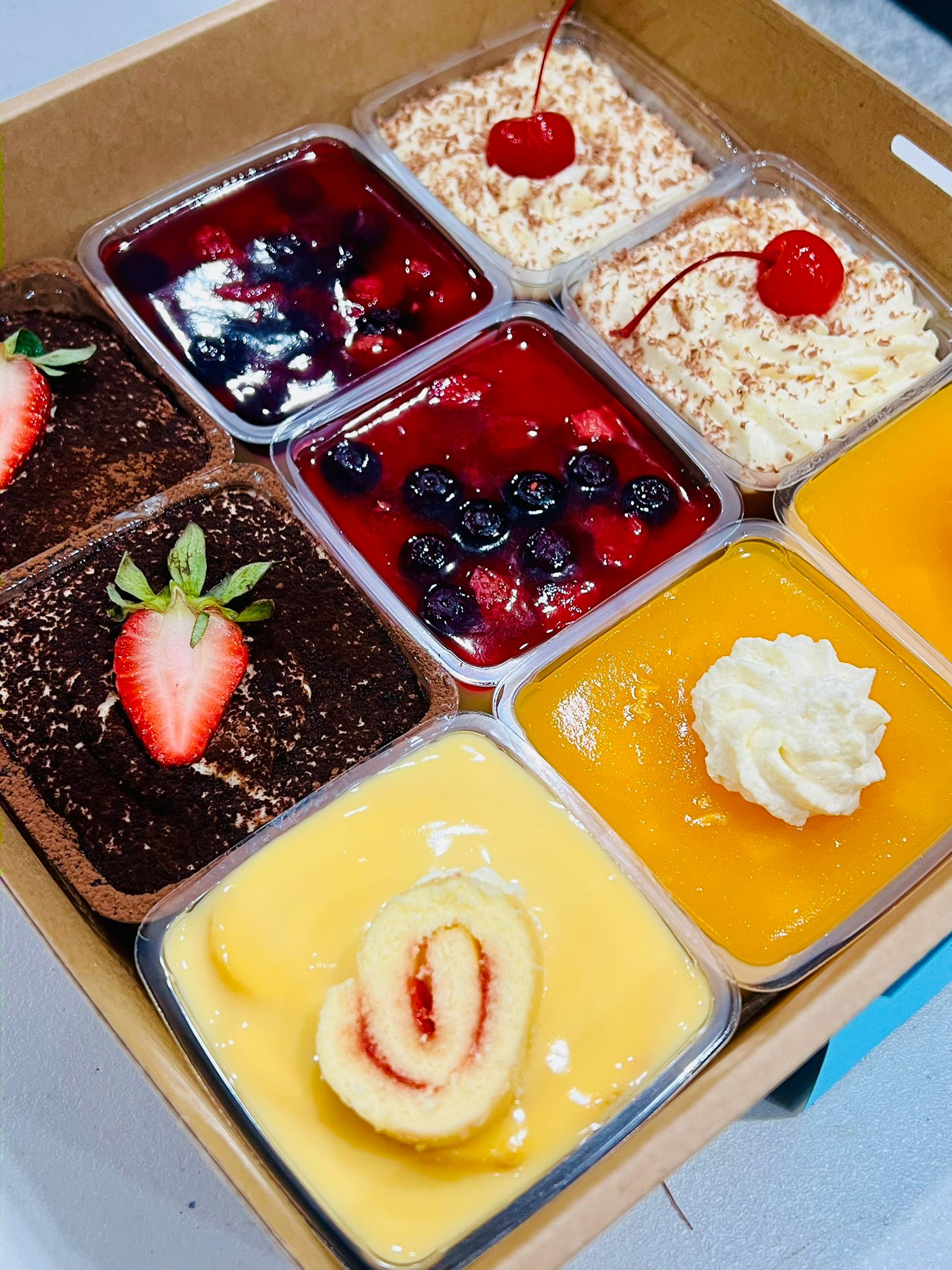 A box of large mini dessert cups in assorted flavours